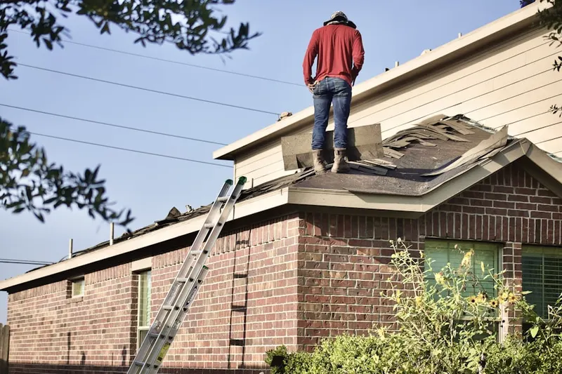 Professional roofer working on a residential roof in Blawenburg
